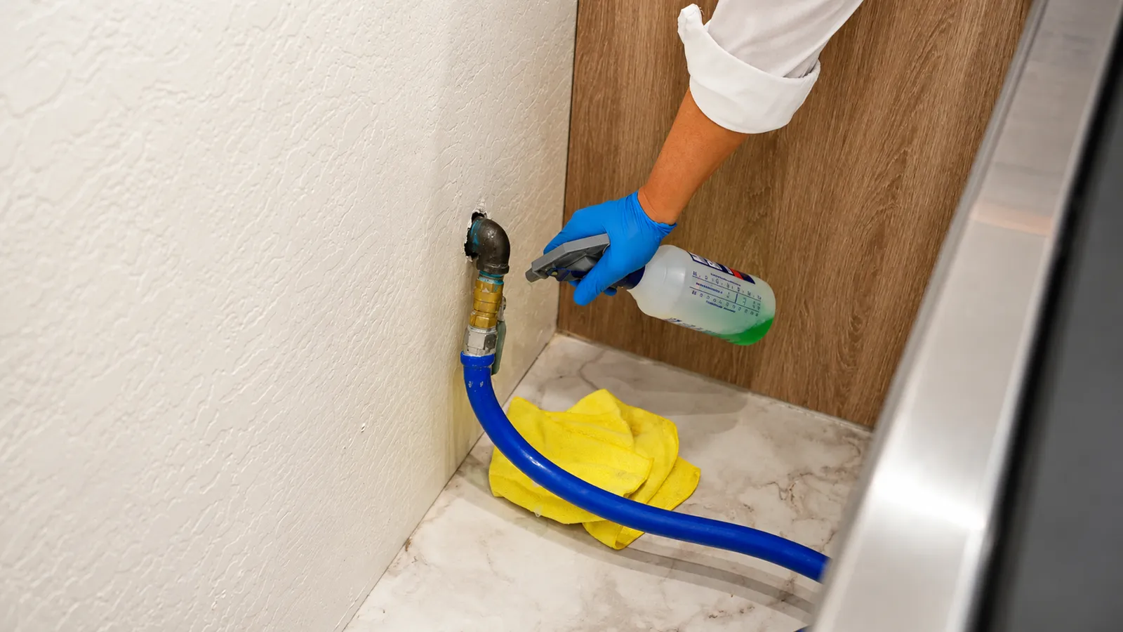 Plumber leak testing a gas line connection